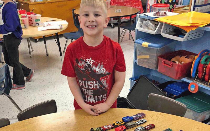 Levit displaying his 100 vehicles on the 100th day of school at Strain-Japan School.