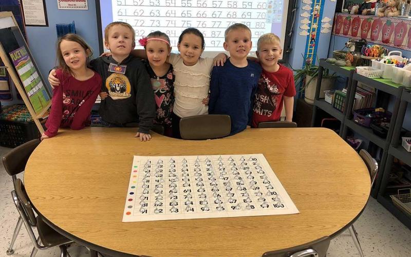 The kindergarten class proud that they were able to find 100 kisses that were hidden in their room.