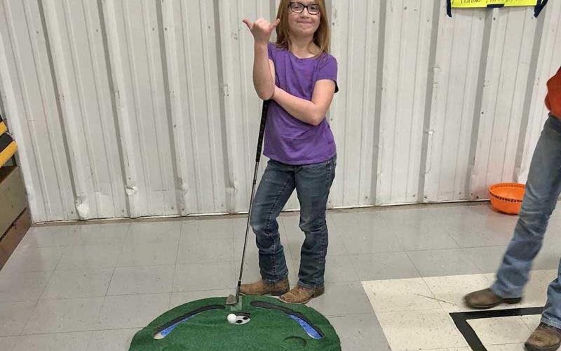 Jordan, second grade student, is excited that she just made a hole-in-one on the golf course at the K-4 event at Strain-Japan School.