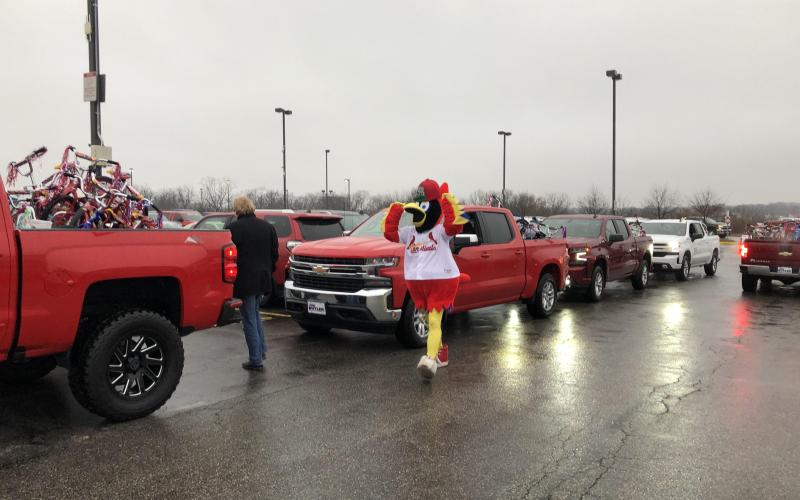 Last year’s caravan of new Chevrolet Silverados loaded up with donated bikes prepares to depart for the event site near the Jim Butler dealership in Gravois Bluffs.