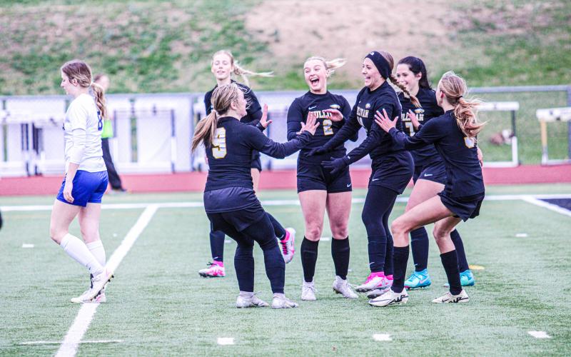 GOOD TIMES. The Lady Eagles surround and cheer on Tessa Newman after she notched Sullivan’s 3rd goal against Fatima on Thursday, Apr. 4. Photo by Wyatt Hardy Article Image Alt Text