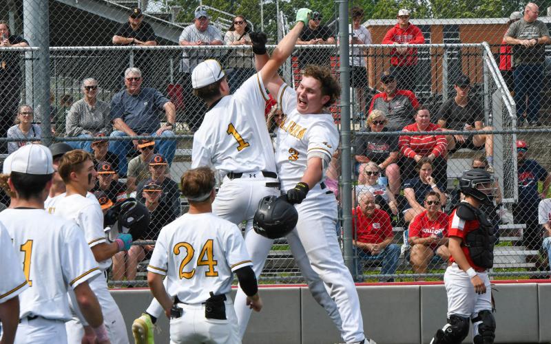 WARM WELCOME HOME. Chase Blue (3) homered for Sullivan’s first score against the Bulldogs. He received a warm welcome home from his teammates and is pictured celebrating with Nate McReynolds (1). The junior was lights out in the district semifinal, leading the Eagles with two runs and two walks. Photo by Extra Innings Photography Article Image Alt Text