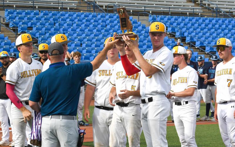 HANG IT IN THE RAFTERS. Senior Drake Gawer is pictured holding Sullivan’s Class 4 third-place plaque after blanking Father Tolton 2-0. The Eagles played in their eighth Final Four in program history and first in ten years. In 2025, Sullivan three-peated districts then rallied to win the sectionals and quarterfinals for Ozark. Photo by Extra Innings Photography Article Image Alt Text