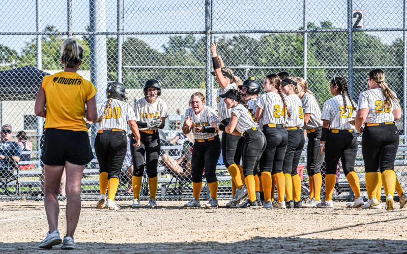 WELCOME HOME. The Lady Eagles celebrate Evvie Blankenship (00) after her home run against Linn. Photo by Wyatt Hardy Article Image Alt Text