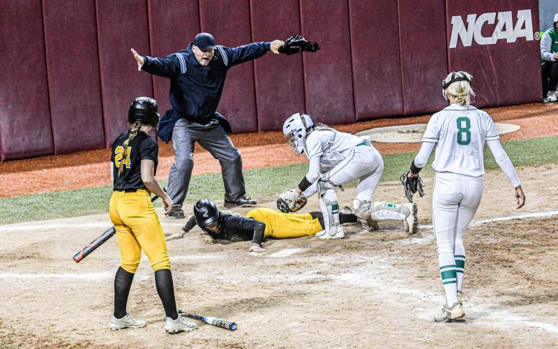CARLI McCREARY is ruled safe on the home plate. Photo by Extra Innings Photography Article Image Alt Text