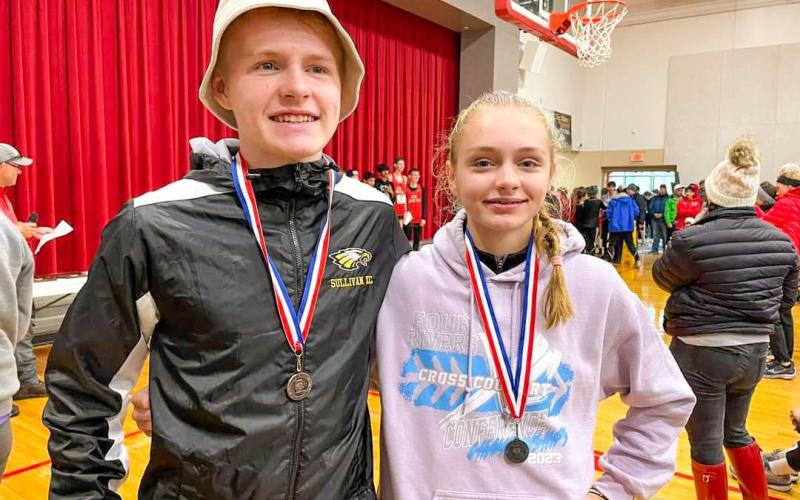 DENNEYS DUO STRIKES AGAIN. Abram Denney (pictured: left) and his sister Mariah (right) both medaled at the Class 4 District 2 tournament in the 5k races. Abram finished with a career-best time and Mariah broke a school record. Photo via Sullivan Cross Country Facebook. Article Image Alt Text