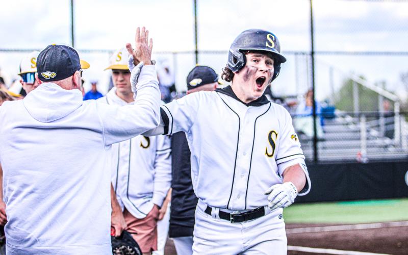 WARM WELCOME HOME. Assistant coach Brian Immekus (left) high-fives Chase Blue (right) after his historic homer. Blue became the first Eagle since Apr. 24, 2017, to hit it out of Sullivan Bank Ballpark. Photo by Wyatt Hardy Article Image Alt Text