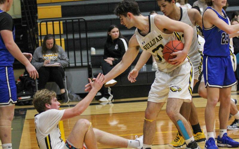 RISE ABOVE. Cooper Donner (right) lent his hand to Peyton Malady (left) and lifted him off the floor. Photo by Wyatt Hardy Article Image Alt Text