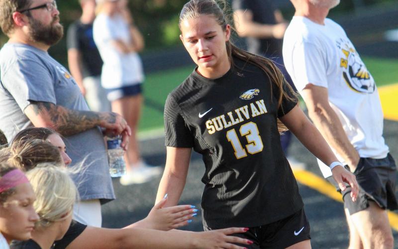 KEEP THE MOMENTUM. Ella Kirk is pictured high-fiving the sideline during Sullivan’s win over Dixon. Photo by Wyatt Hardy Article Image Alt Text
