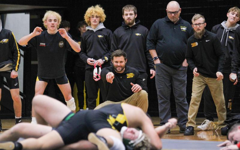 JAWS OF DEFEAT. The sideline is pictured cheering on Brennan Birrer in the Ste. Genevieve dual. Despite being brought down many times, Birrer rallied for a win. Photo by Wyatt Hardy Article Image Alt Text