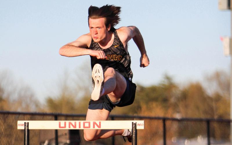 JAYSON SUMMERS pictured leaping over a hurdle. Photo by Wyatt Hardy Article Image Alt Text