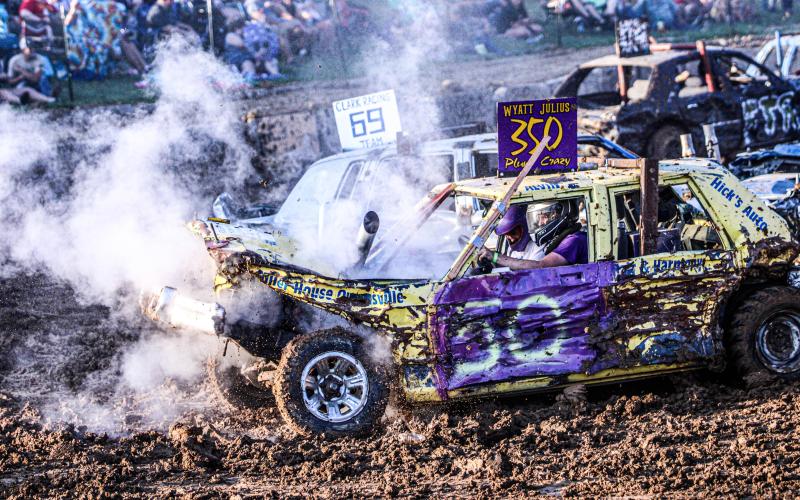 CRASH N’ BURN. Driver Wyatt Julius trudges on despite his smoking vehicle. Photo by Wyatt Hardy Article Image Alt Text