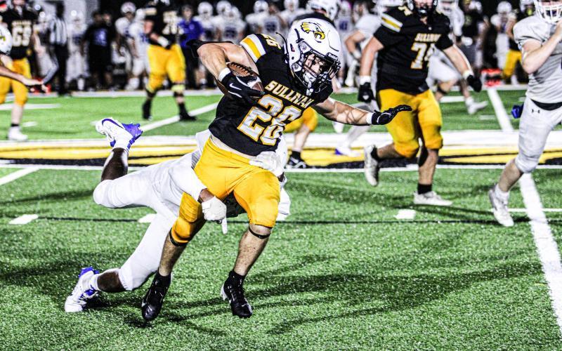 GAME OF INCHES. Mark Jennings (26) used his legs to move the chains. Photo by Wyatt HArdy Article Image Alt Text