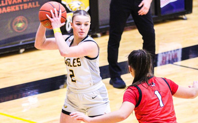 MOLLY LOHDEN (2) looks for someone to pass to as a Lady Tiger tries to claw the ball away from her. Photo by Wyatt Hardy @ 2/5 St. James vs. Sullivan game Article Image Alt Text