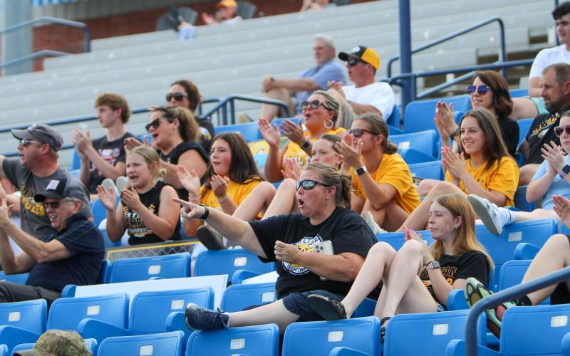 ROAR OF THE CROWD. Sullivan’s fans are pictured cheering in the third-place matchup after catcher Alex Toews tagged a runner out at home plate. Photo by Wyatt Hardy Article Image Alt Text