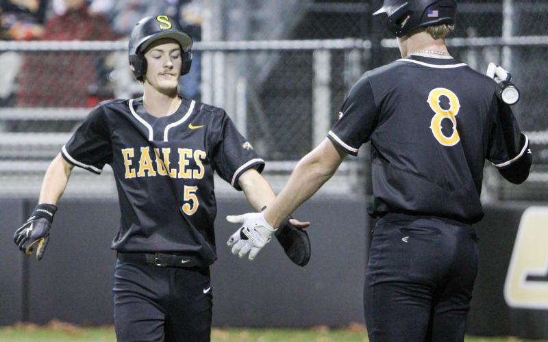 SOUND OF VICTORY. Seth Valley (5) scores and high-fives Drake Gawer (8). Photo by Wyatt Hardy Article Image Alt Text