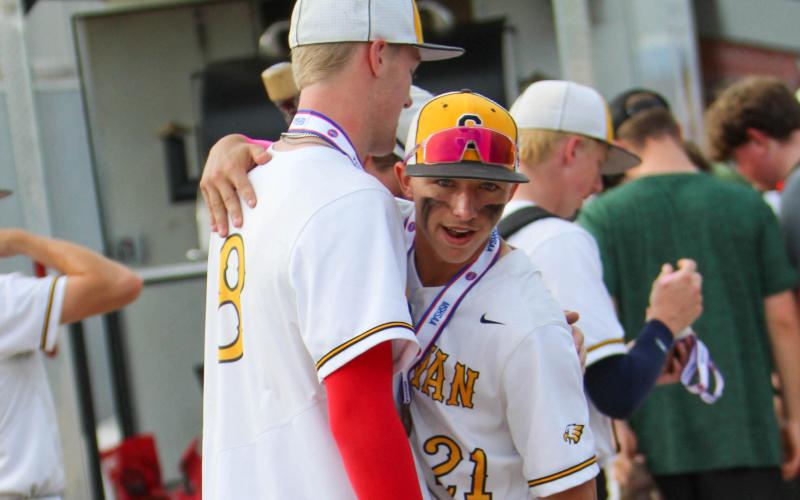 CARRY THE TORCH. Drake Gawer (left) hugs Raiden Redd (right) after playing together for one last time. Photo by Wyatt Hardy Article Image Alt Text