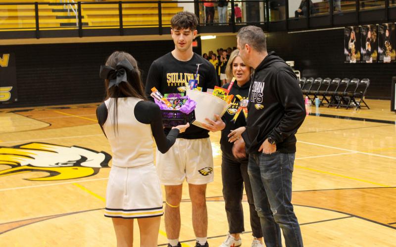 BOYS BASKETBALL SENIOR NIGHT. Before the Eagles clawed out the Wildcats, they held their senior night ceremony. Sullivan recognized its five graduating players: Chris Glaser, Seth Valley, Robert York, Brayden White and Cooper Donner. Donner, a 6’4 forward, is pictured with his parents at the ceremony. Photo by Wyatt Hardy Article Image Alt Text