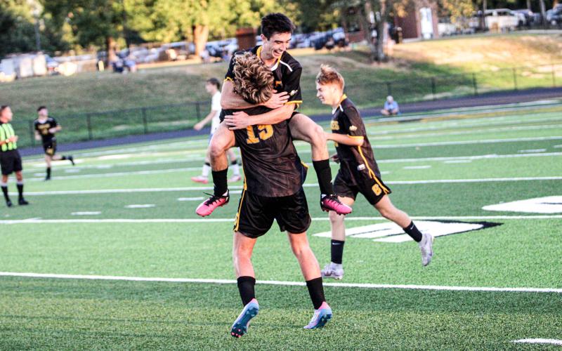 JOSIAH TANNER scored the final goal against Crocker and hugged Logan Schlueter (15) afterward. Photo by Wyatt Hardy Article Image Alt Text