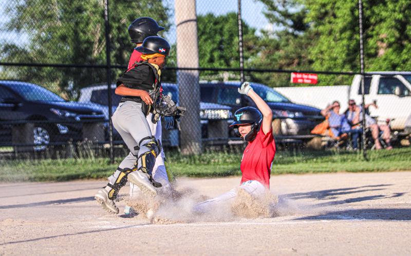 SURF THE DIRT. Eaton’s runner Ty Hassard crash landed into home plate, making another wave for the Cardinals in their 15-1 victory over The Hitting Spot. Photo by Wyatt Hardy Article Image Alt Text