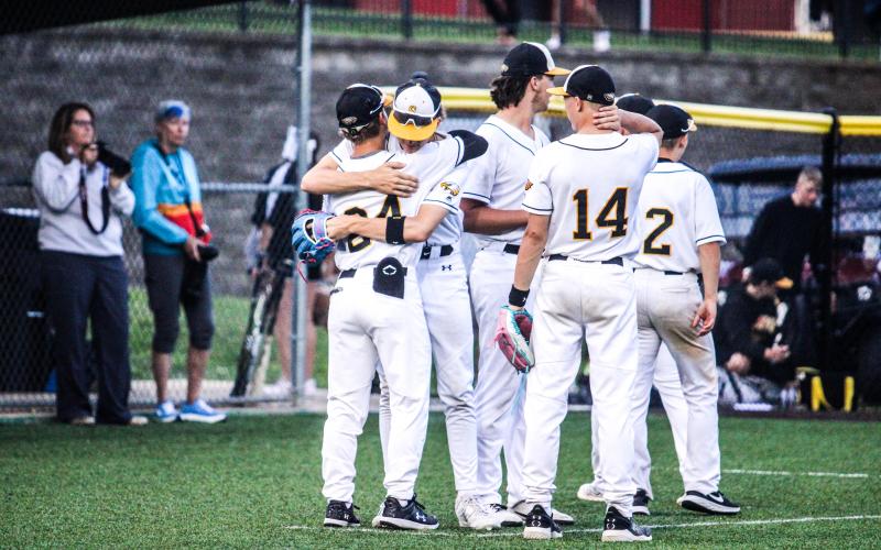 ONE MORE GAME. Nate McReynolds hugs Alex Toews before the first pitch. Photo by Wyatt Hardy Article Image Alt Text