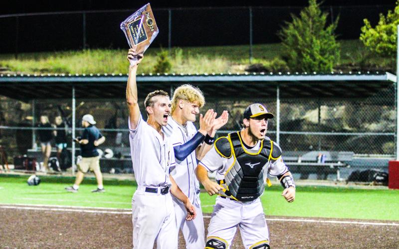ONE LAST RIDE. From left to right, seniors Gavin Schmidt, Cambrian Koch and Dayton Skaggs celebrate their final district title. They hope to make the most of their last ride as Sullivan Eagles at state. Photo by Wyatt Hardy Article Image Alt Text