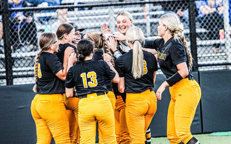 WELCOME HOME. The Lady Eagles cheer on Dorie Richardson after a homer. Photo by Wyatt Hardy Article Image Alt Text