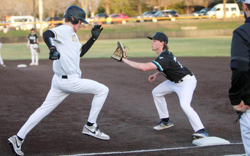 BRODY GAWER (left) squeezes his way to first base. He grabbed an RBI and a hit. Photo by Wyatt Hardy Article Image Alt Text