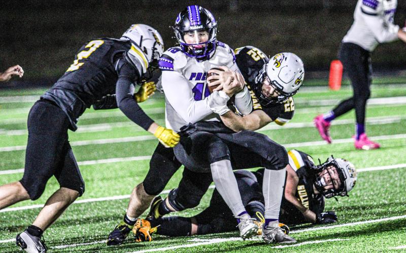 BLACK SWARM. Sullivan defenders Grant Halmick (2) and Parker Montee (22) are pictured making a sack. Photo by Wyatt Hardy Article Image Alt Text