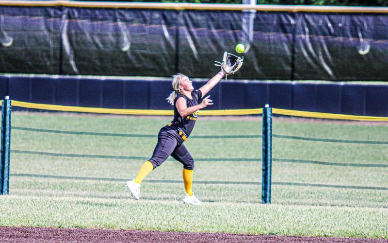 OVER THE FENCE. Molly Lohden dove and stretched her arm to snag a clutch out during practice. Photo by Wyatt Hardy Article Image Alt Text