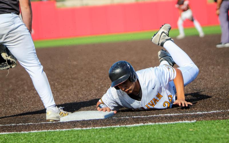 BRING THE BOOM. Nathan Garcia slides to first. Photo by Wyatt Hardy Article Image Alt Text