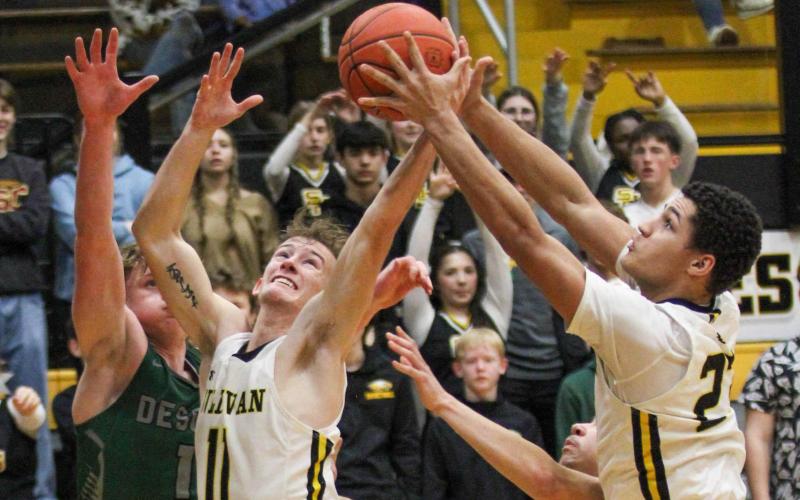 DANCE WITH DRAGONS. Seth Valley (11) and Robert York (23) tussels with Desoto for the ball. Photo by Wyatt Hardy Article Image Alt Text