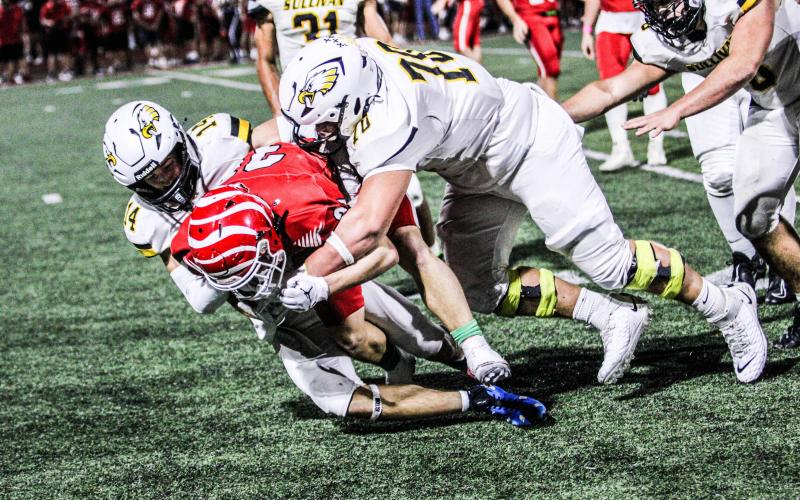 SENIOR CAPTAINS Seth Valley (14) and Nolan Center (70) shut down a quarterback scramble. Photo by Wyatt Hardy Article Image Alt Text