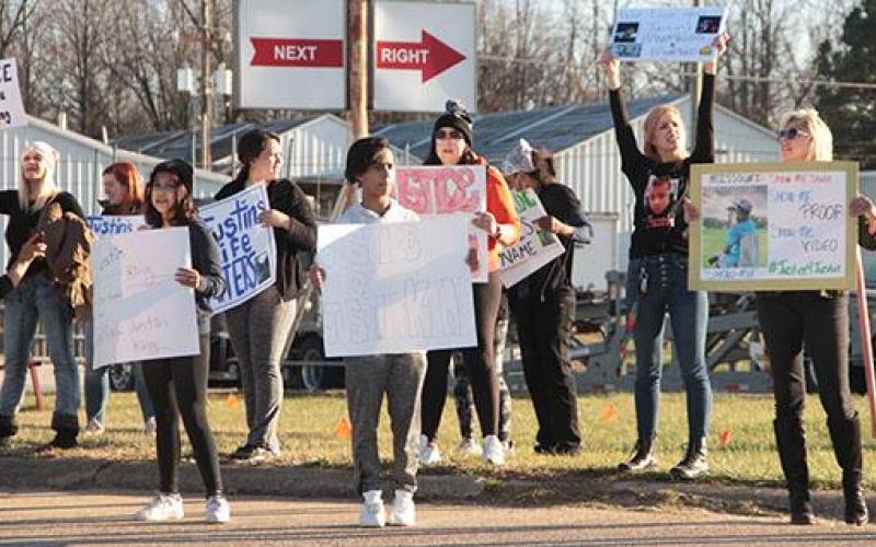Protestors seeking justice for Justin King hold up signs during a December rally in Bourbon. Article Image Alt Text
