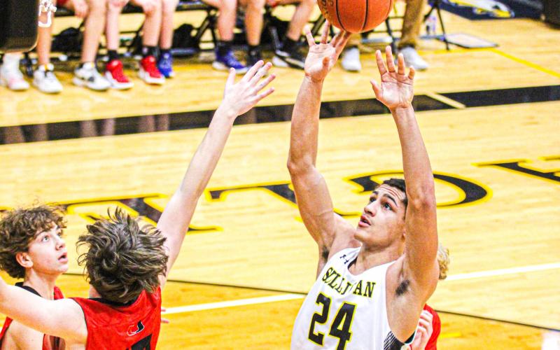 ROBERT YORK (24) hits a jumper in his first game of the season in the C-team's 33-27 victory over Union. He and his brother, Cameron York, were key factors in Sullivan’s win. Photo by Wyatt Hardy. Article Image Alt Text