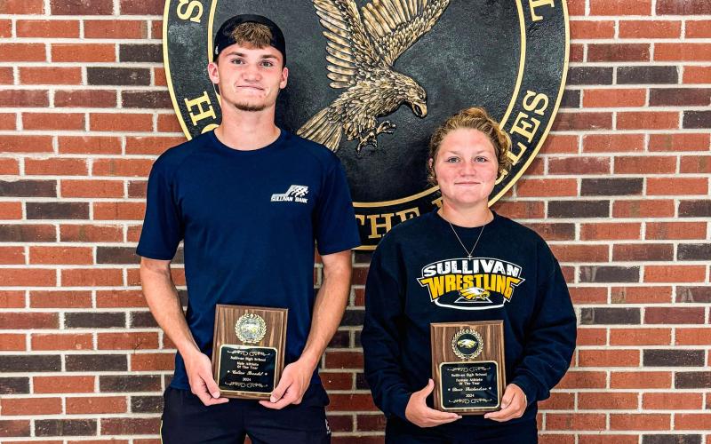 2023-24 SHS ATHLETES OF THE YEAR. Colton Brendel (left) and Dorie Richardson (right) soared above and beyond as Eagle all-stars this school year. Holding their plaques, they will join the long list of other Sullivan High School legends. Photo via Sullivan Eagles X Article Image Alt Text