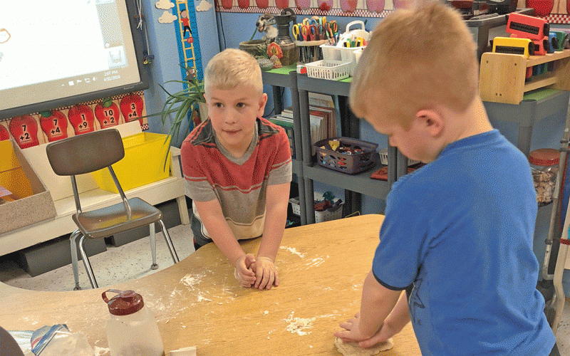 STRAIN-JAPAN STUDENTS, Levi and Jett busily kneading their bread dough.