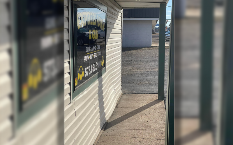 The damage from the accident is quite visible on the front wall of Express Pawn as the vehicle hopped the concrete car barrier and struck the wall, causing what was described as a “loud bang” by customers inside the store.