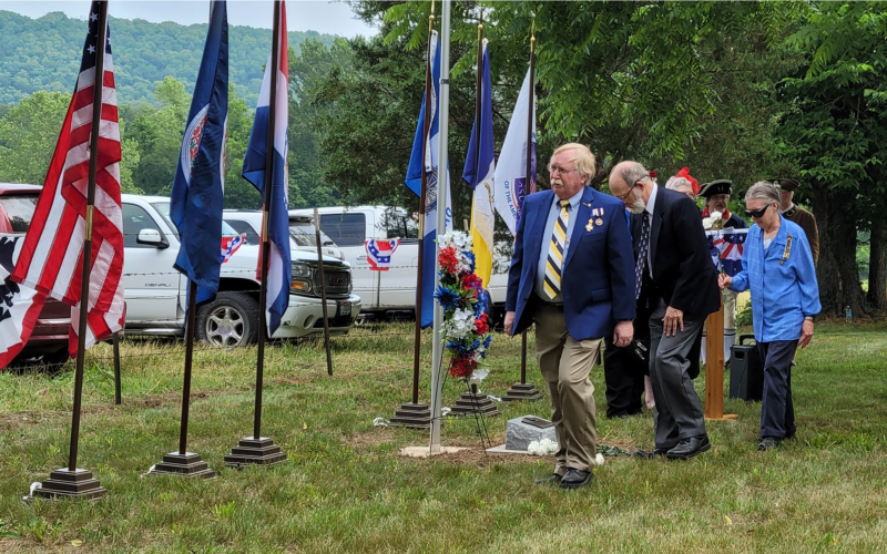 Sons of the American Revolution placing flowers by the grave marker. Sons of the American Revolution placing flowers by the grave marker.