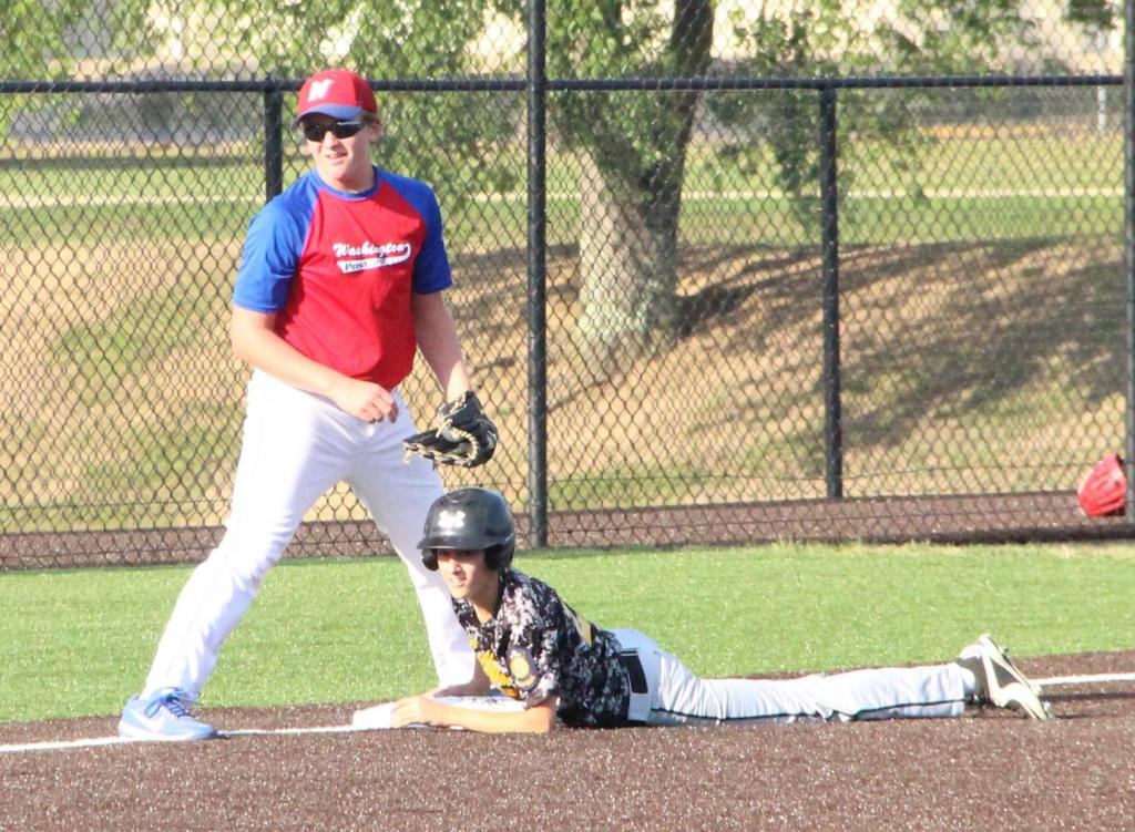 Andrew Bell slides safely into third after moving up on a passed ball