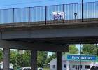 A sign saying "I Can't Breathe" hangs on the James K. Schatz Memorial Bridge in Sullivan Article Image Alt Text