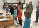 Students and parents from the Strain-Japan School District observing the materials presented at the Middle School Science fair by Mr. Rodney Angell.