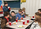 Strain-Japan students enjoying a pizza and salad supper following the Title I Family Night.