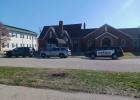 three police vehicles parked in front of a funeral home