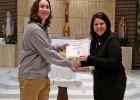 MRS. MALLORY IS presented with the Distinguished Educator Award from Borgia High School senior Jack Wooley.