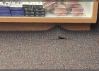 Due to the displacement of the exterior wall, the carpeting can be seen “pinched up” at various transition points. Due to the displacement of the exterior wall, the carpeting can be seen “pinched up” at various transition points.